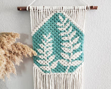 Load image into Gallery viewer, Hand painted macrame botanical wall hanging. Boho inspired home decor. Modern wall art for bedroom and living room.