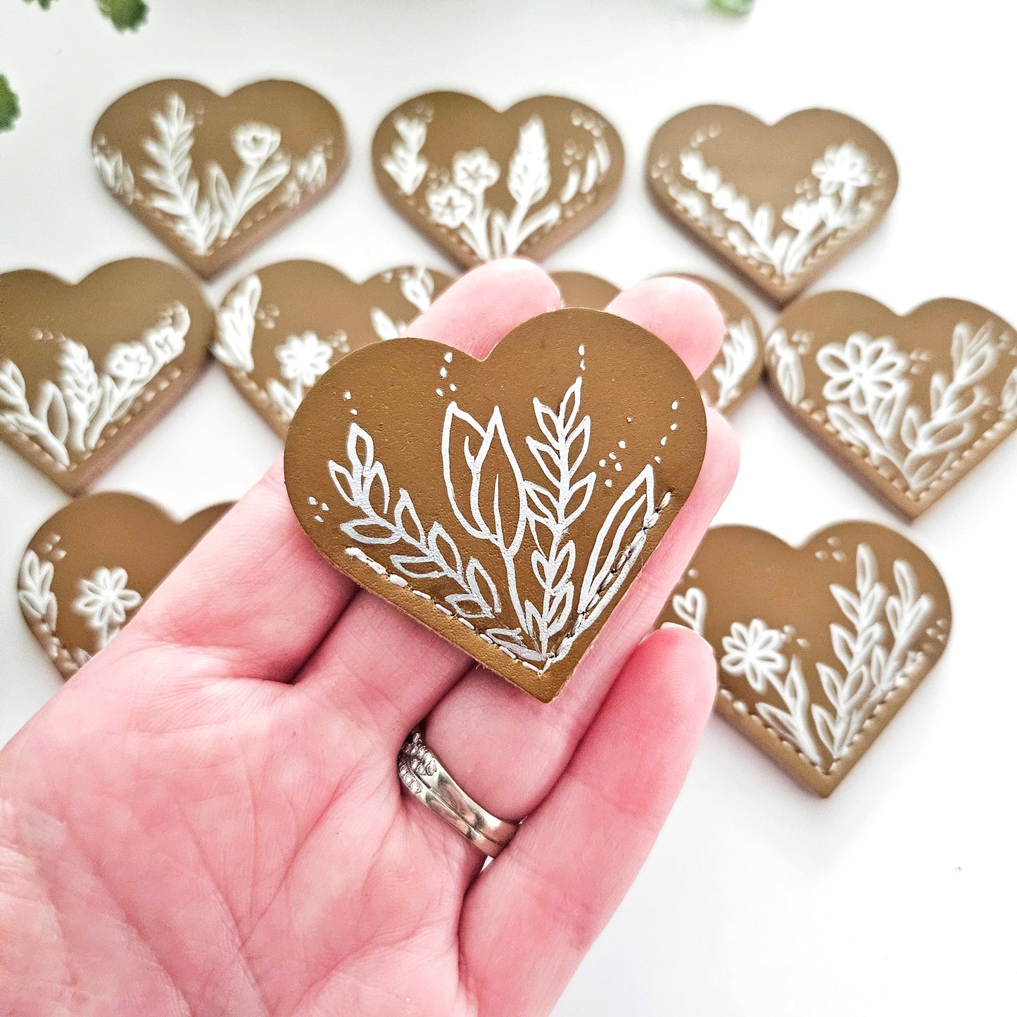 Leather Heart Bookmarks with Exquisite Hand-Drawn Metallic Botanical Designs for book lovers.